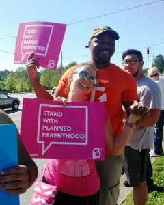 Pro-abortion activists hold signs promoting Planned Parenthood 